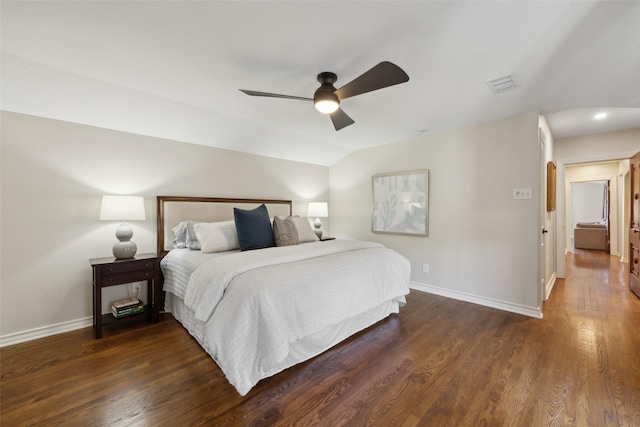 bedroom featuring ceiling fan, dark hardwood / wood-style floors, and vaulted ceiling