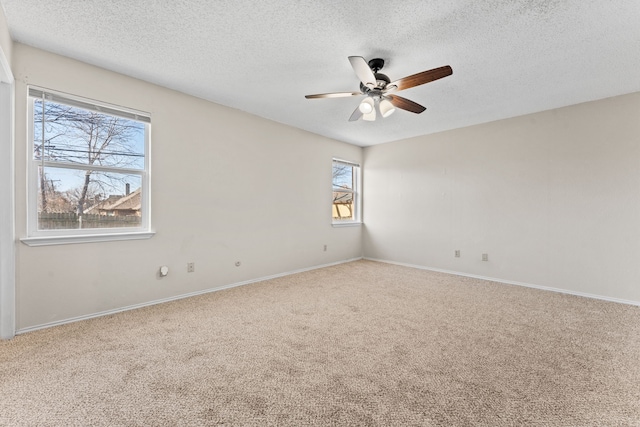 spare room with ceiling fan, a textured ceiling, and carpet flooring