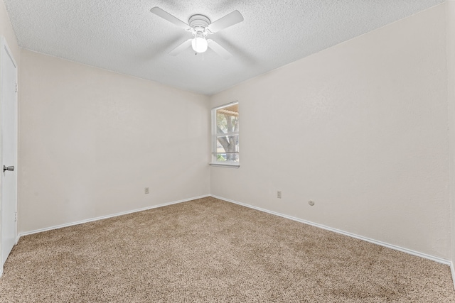 carpeted empty room featuring ceiling fan and a textured ceiling