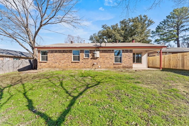 back of house with a patio area and a lawn