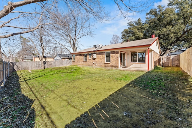 rear view of house featuring a yard