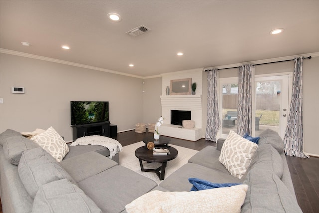 living room featuring crown molding, a fireplace, and dark hardwood / wood-style floors