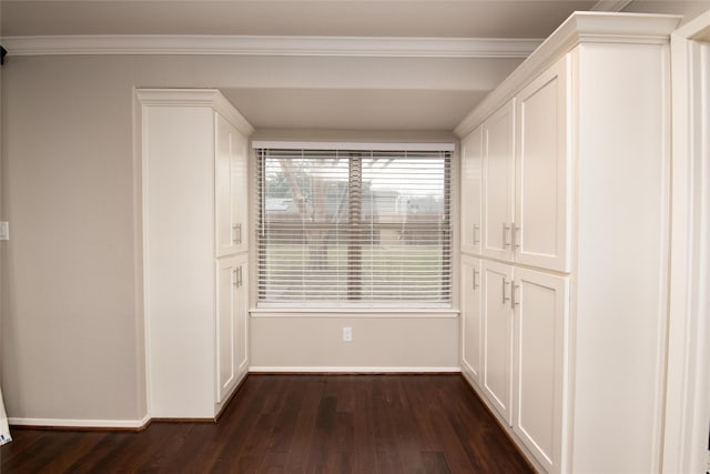 hall with ornamental molding and dark hardwood / wood-style floors