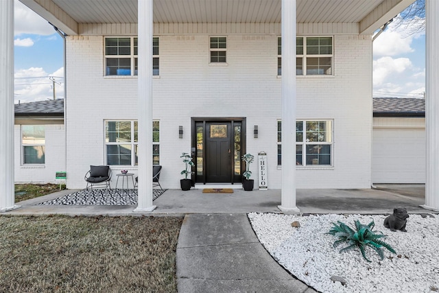 property entrance featuring a garage and covered porch