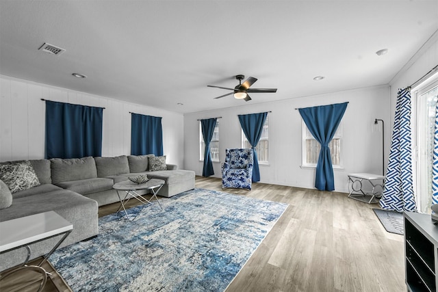 living room with ceiling fan and light hardwood / wood-style floors