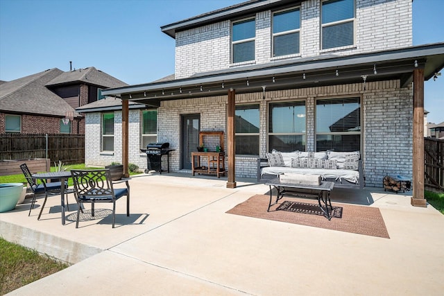 view of patio featuring fence, outdoor lounge area, and area for grilling