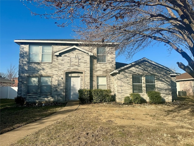 view of front of property featuring a front yard and central AC unit