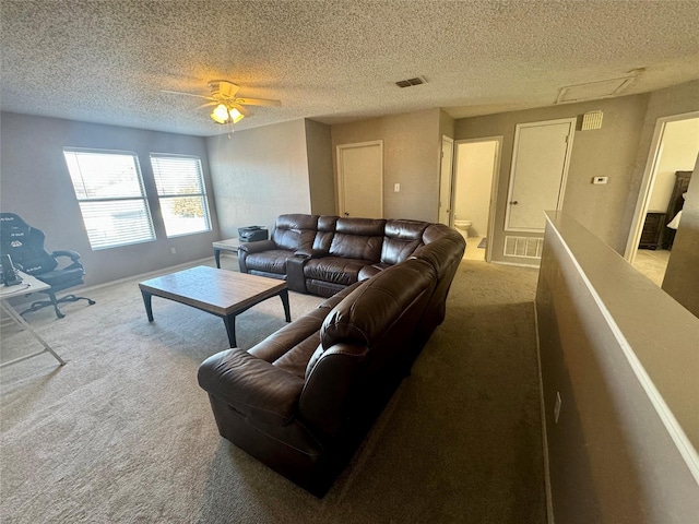 carpeted living room with a textured ceiling and ceiling fan