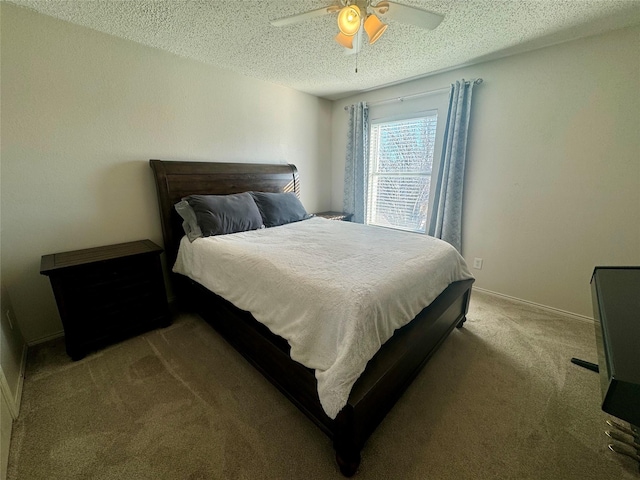 carpeted bedroom with ceiling fan and a textured ceiling