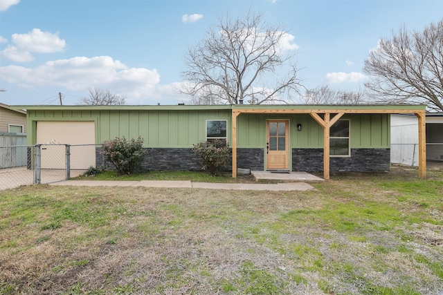 ranch-style house with a garage and a front yard