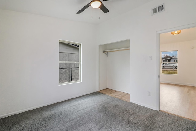 unfurnished bedroom with carpet floors, ceiling fan, and a closet