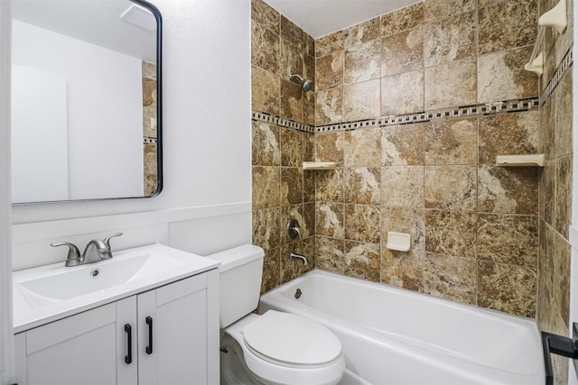 full bathroom with vanity, toilet, and tiled shower / bath