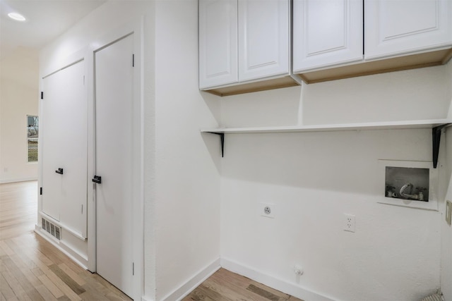 clothes washing area with light wood-type flooring, cabinets, hookup for a washing machine, and electric dryer hookup