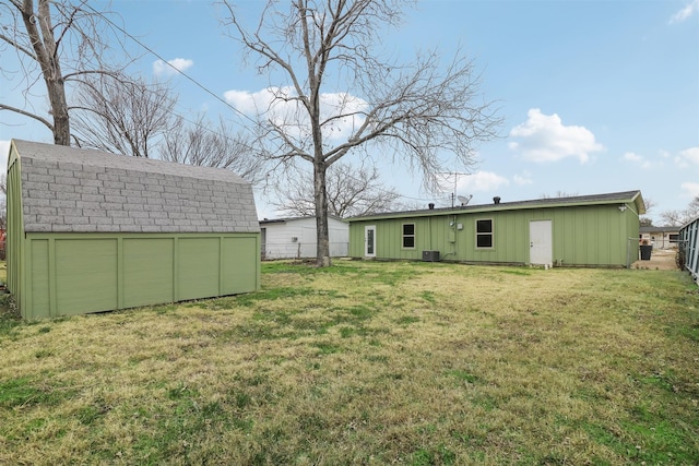 view of yard featuring a storage unit and central air condition unit