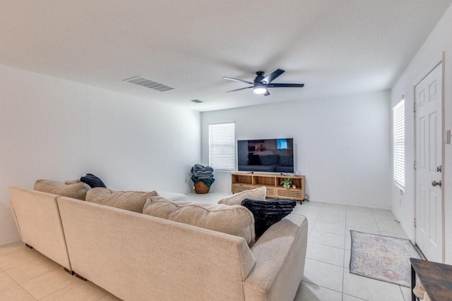 living room featuring light tile patterned floors and ceiling fan