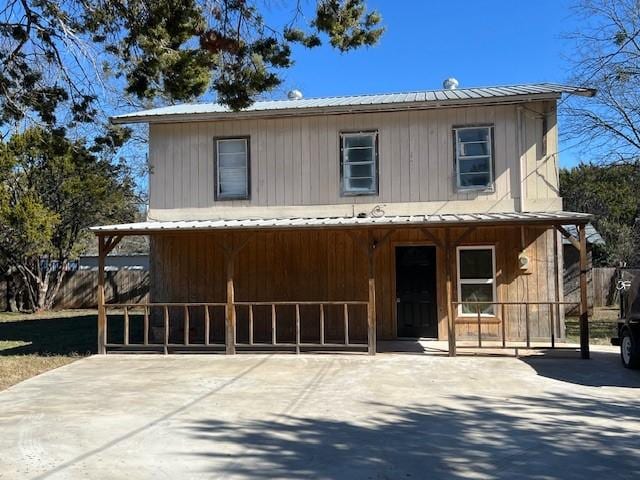 view of front of property with metal roof and driveway