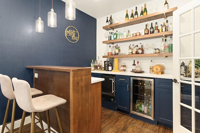 bar with wine cooler, hanging light fixtures, indoor wet bar, and dark wood-style flooring