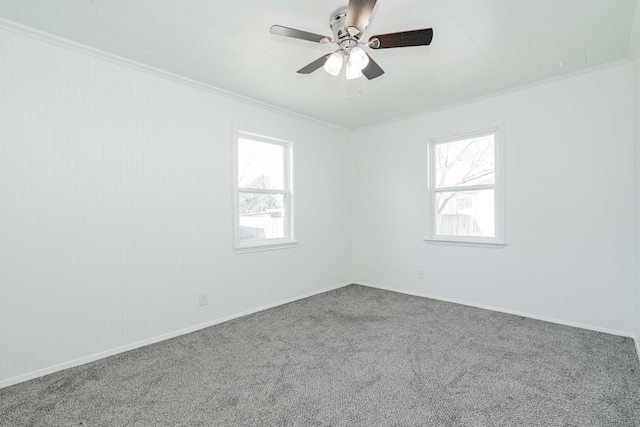 carpeted empty room with ornamental molding and ceiling fan