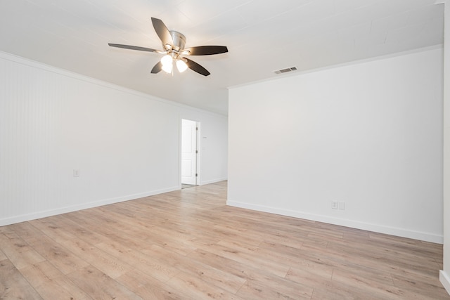 empty room with ceiling fan, ornamental molding, and light hardwood / wood-style floors