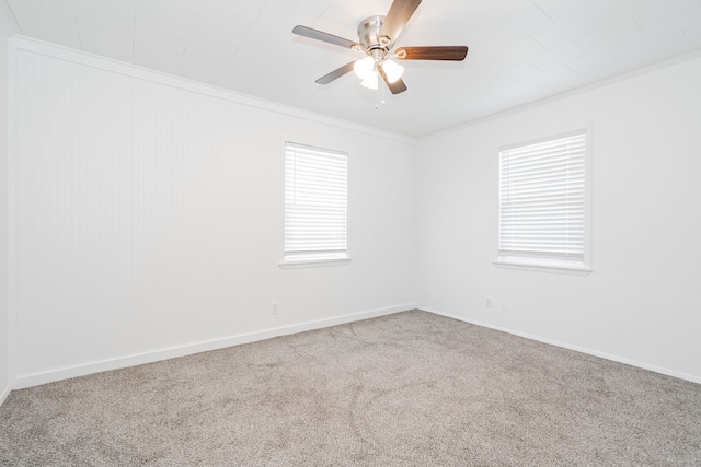 carpeted empty room with crown molding and ceiling fan