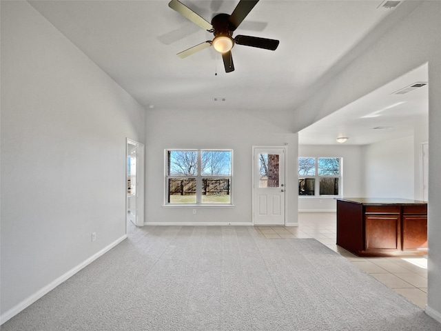 unfurnished living room with light tile patterned floors and ceiling fan