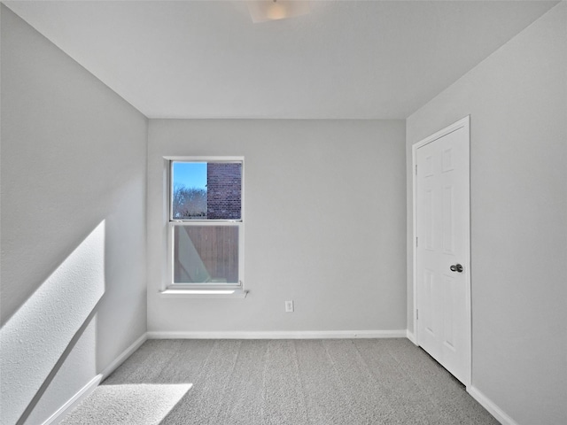 unfurnished room with light carpet