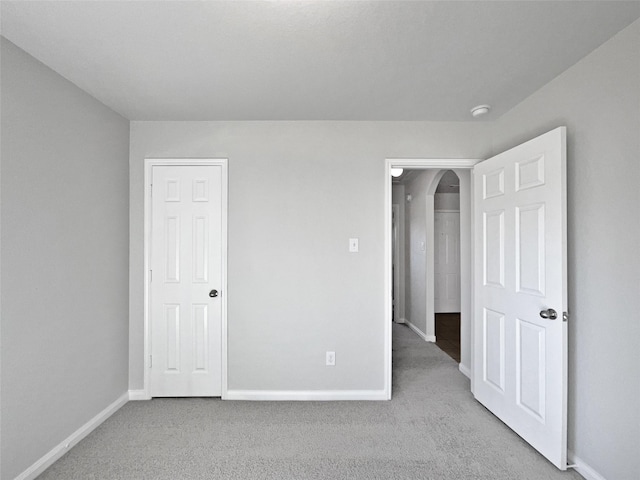 unfurnished bedroom with light carpet