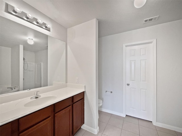 bathroom featuring vanity, tile patterned floors, and toilet