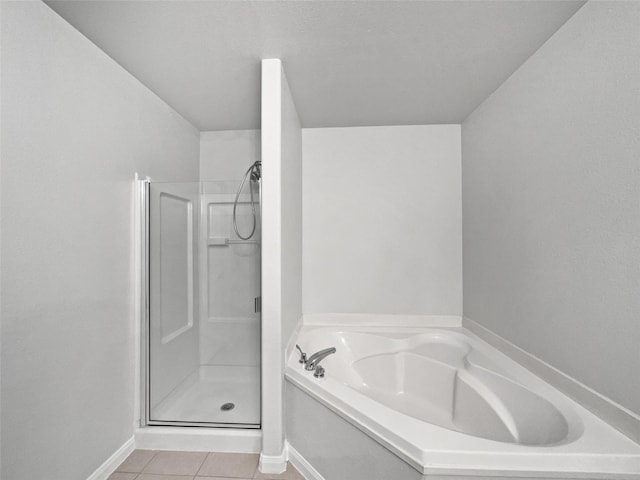 bathroom with tile patterned flooring and separate shower and tub