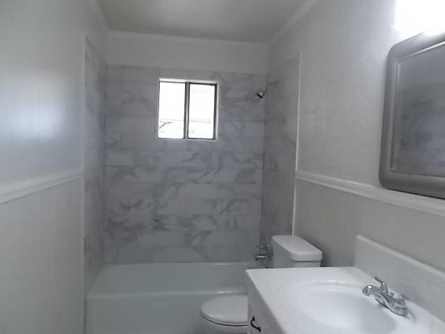 full bathroom with tiled shower / bath combo, vanity, and toilet