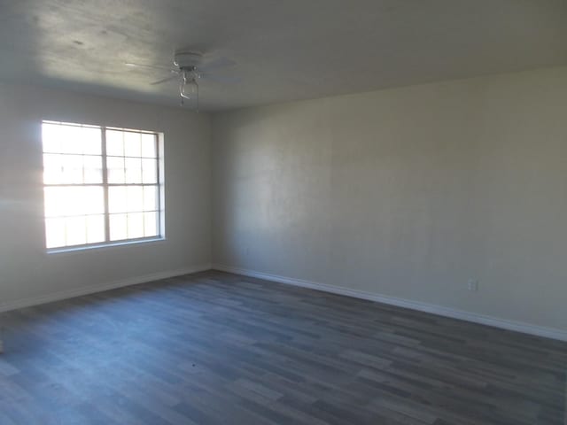 spare room with ceiling fan and dark hardwood / wood-style flooring