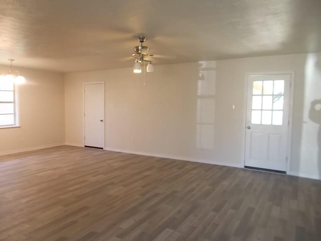 unfurnished room featuring dark hardwood / wood-style floors and ceiling fan