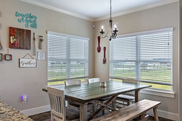 dining space with crown molding, dark hardwood / wood-style floors, and a notable chandelier