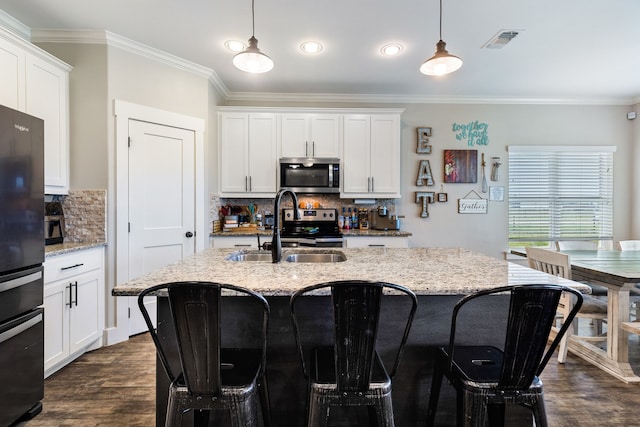 kitchen featuring pendant lighting, sink, and light stone countertops