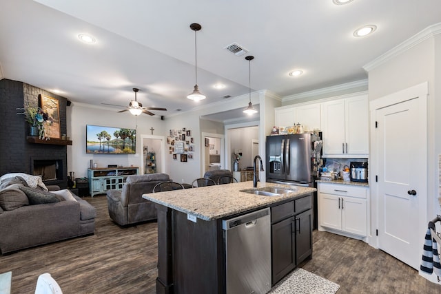 kitchen featuring sink, dishwasher, white cabinets, and light stone countertops