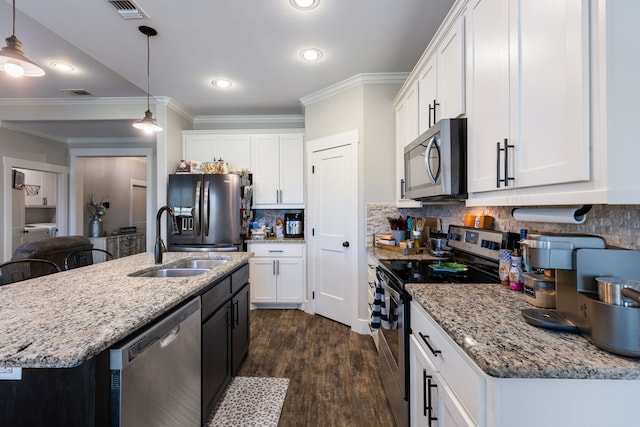 kitchen featuring hanging light fixtures, appliances with stainless steel finishes, sink, and white cabinets