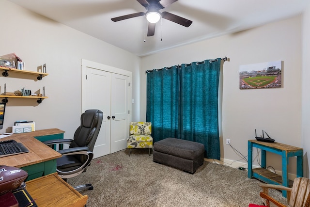 carpeted office space featuring ceiling fan