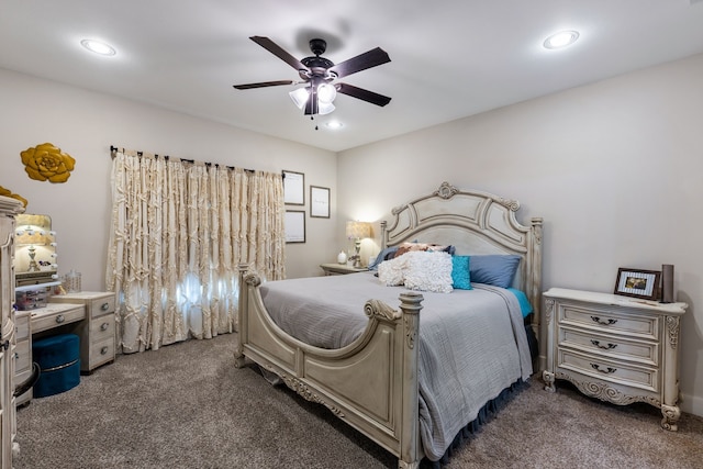 bedroom with ceiling fan and dark carpet