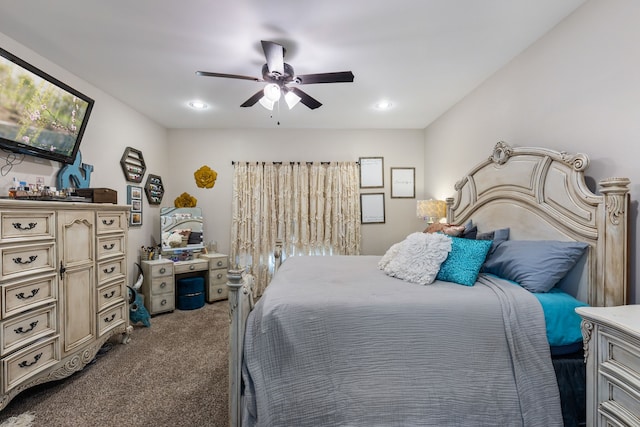 bedroom with ceiling fan and dark colored carpet