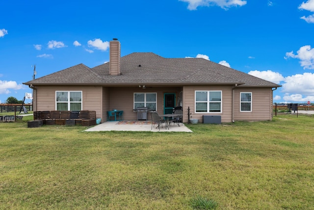 back of property featuring a patio and a lawn