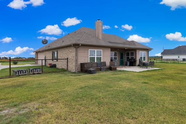 rear view of property featuring a patio and a yard