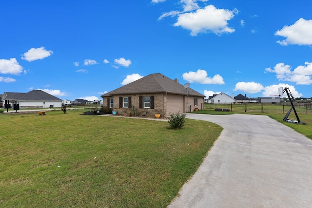 view of front of home featuring a garage and a front yard