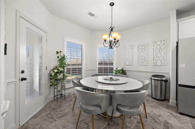 dining space with a notable chandelier