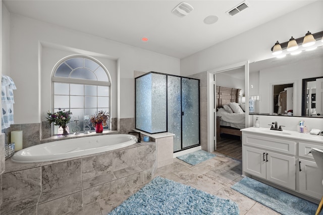 bathroom featuring vanity, tile patterned flooring, and shower with separate bathtub