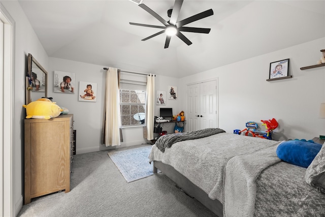 carpeted bedroom with vaulted ceiling, a closet, and ceiling fan