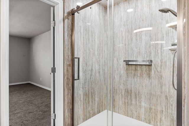 bathroom featuring a stall shower and baseboards