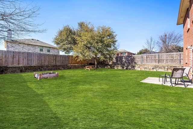 view of yard featuring a patio area and a fenced backyard