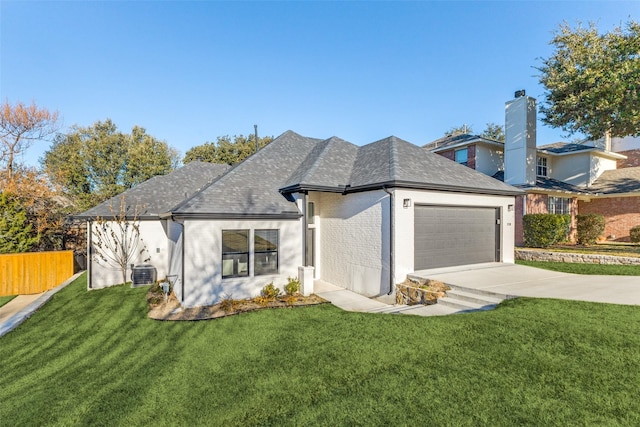 view of front of house featuring central AC unit, a garage, and a front lawn