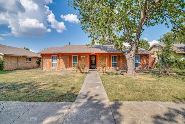 ranch-style home featuring a front yard