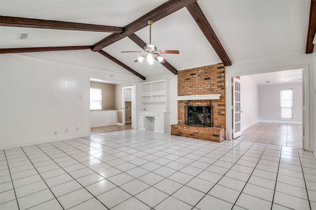 unfurnished living room with vaulted ceiling with beams, light tile patterned floors, built in features, ceiling fan, and a fireplace